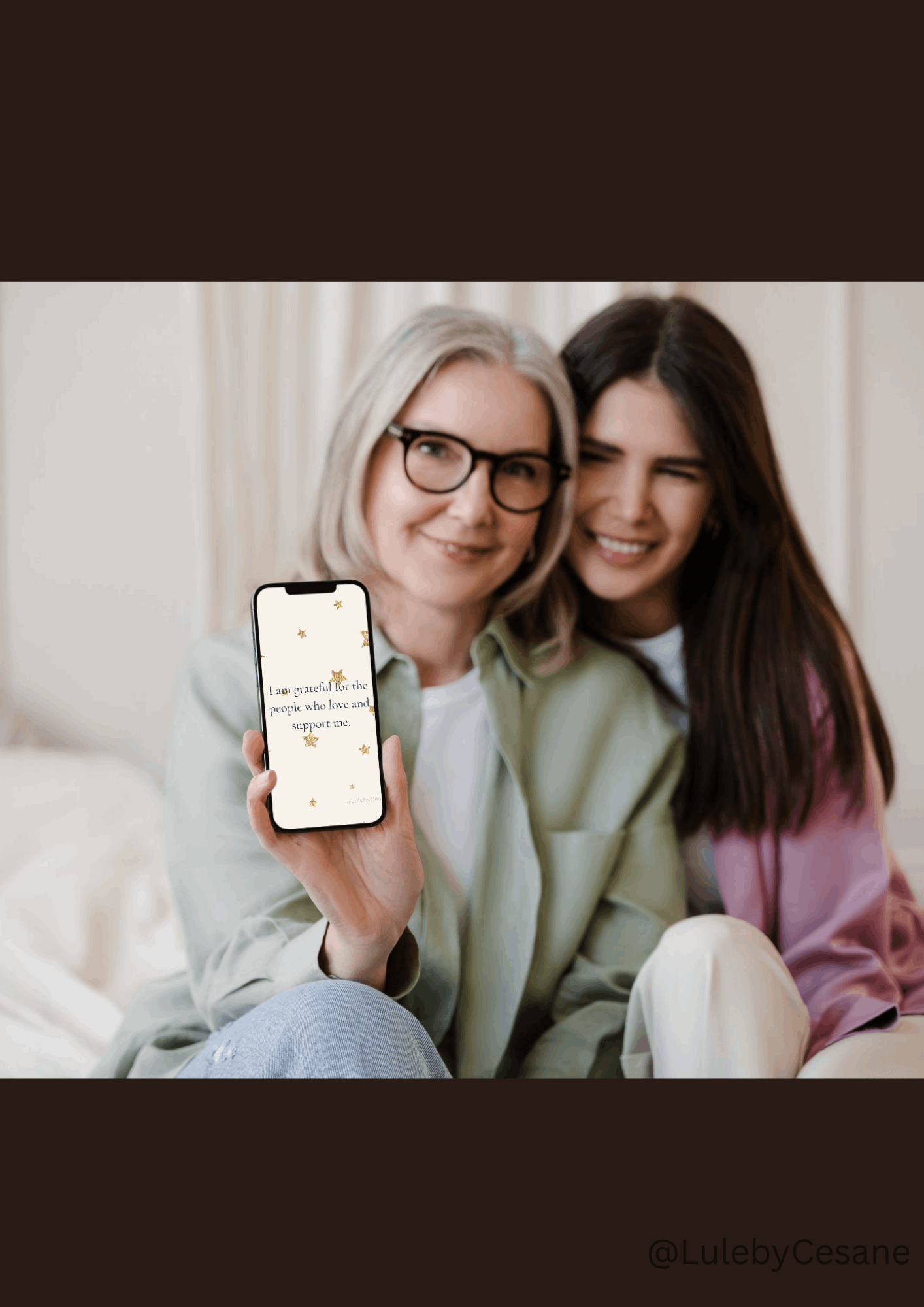 Two women using daily affirmation cards on phone for mindfulness practice and wellness routine.
